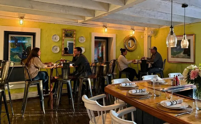 Two couples sitting at high top tables in the bar area